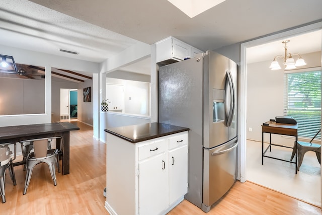 2123 Sunrise Trl, Richardson, TX 75081 - kitchen featuring stainless steel fridge, light wood-type flooring, white cabinets, and dark countertops