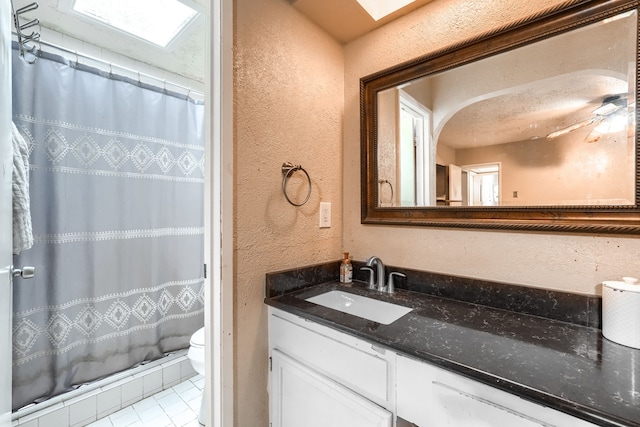 2123 Sunrise Trl, Richardson, TX 75081 - full bathroom featuring a textured wall, vanity, a shower with curtain, a ceiling fan, and tile patterned floors