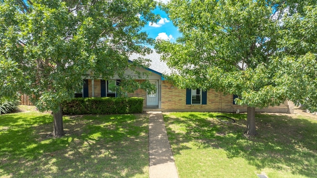 2123 Sunrise Trl, Richardson, TX 75081 - view of property hidden behind natural elements featuring a front yard and brick siding