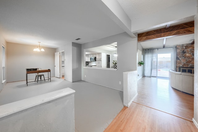 2123 Sunrise Trl, Richardson, TX 75081 - kitchen with stainless steel microwave, beamed ceiling, light wood-style floors, a desk, and a chandelier