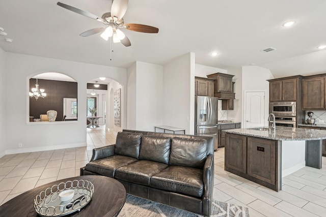 1512 Nighthawk Ln, Mansfield, TX 76063 - living room featuring arched walkways, ceiling fan, light tile patterned flooring, recessed lighting, and baseboards