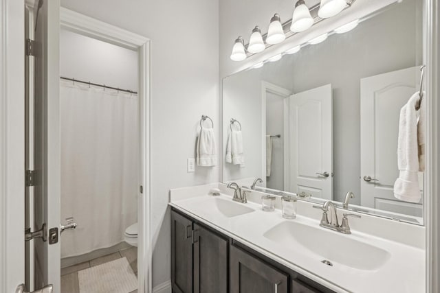 1512 Nighthawk Ln, Mansfield, TX 76063 - full bathroom featuring double vanity, toilet, curtained shower, and tile patterned flooring