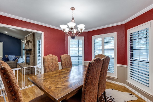 2401 Kingston Trce, Denton, TX 76209 - dining room featuring a chandelier, wood finished floors, and ornamental molding