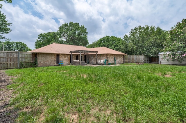2401 Kingston Trce, Denton, TX 76209 - rear view of house featuring a pergola, brick siding, and an outbuilding