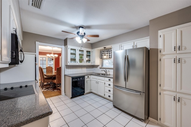 2401 Kingston Trce, Denton, TX 76209 - kitchen featuring black appliances, a sink, a chandelier, ceiling fan, and white cabinetry