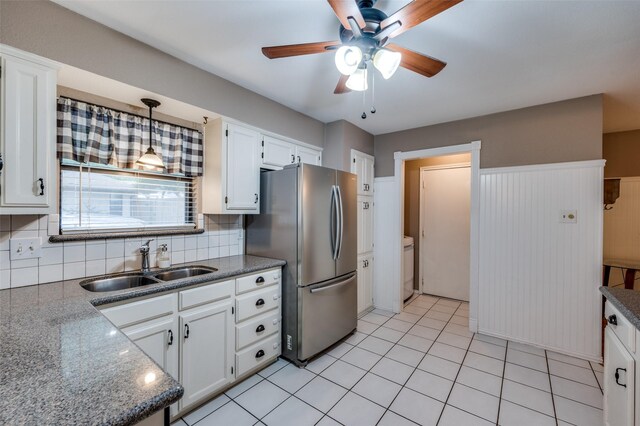 2401 Kingston Trce, Denton, TX 76209 - kitchen with a sink, freestanding refrigerator, ceiling fan, white cabinets, and tasteful backsplash