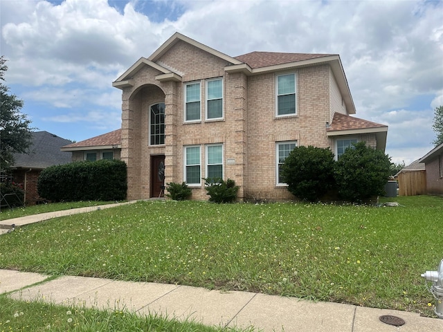 2225 W Appaloosa Dr, Lancaster, TX 75146 - traditional-style house featuring brick siding, central air condition unit, a front yard, and a shingled roof
