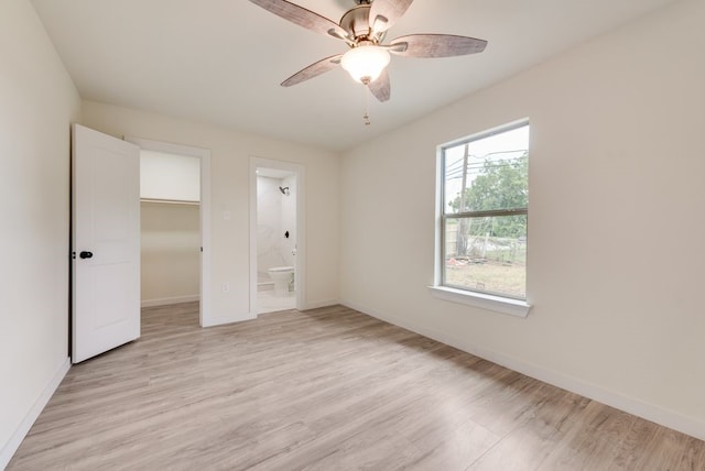 4901 Wilmington Dr, Fort Worth, TX 76107 - unfurnished bedroom with light wood-type flooring, baseboards, a walk in closet, and ensuite bathroom