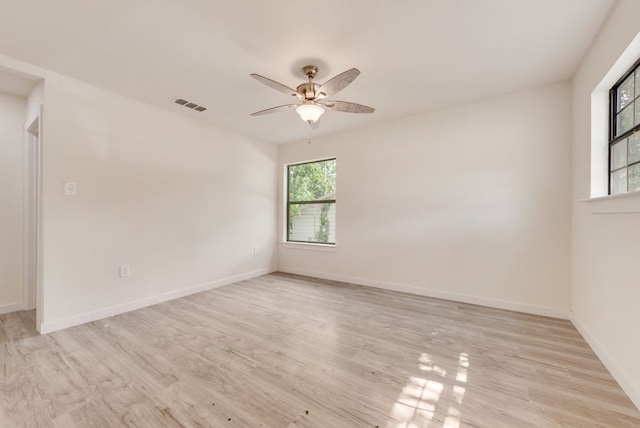 4901 Wilmington Dr, Fort Worth, TX 76107 - spare room featuring healthy amount of natural light, light wood-style floors, a ceiling fan, and baseboards