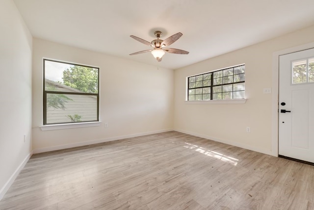 4901 Wilmington Dr, Fort Worth, TX 76107 - foyer featuring healthy amount of natural light, light wood-style flooring, ceiling fan, and baseboards