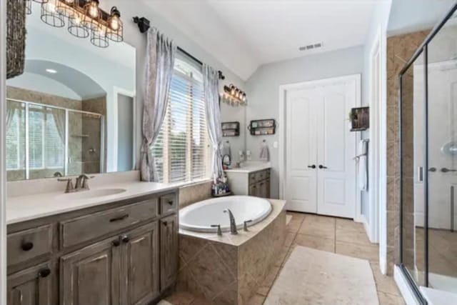 1104 Killian Dr, Mansfield, TX 76063 - bathroom featuring two vanities, a shower stall, a bath, and healthy amount of natural light