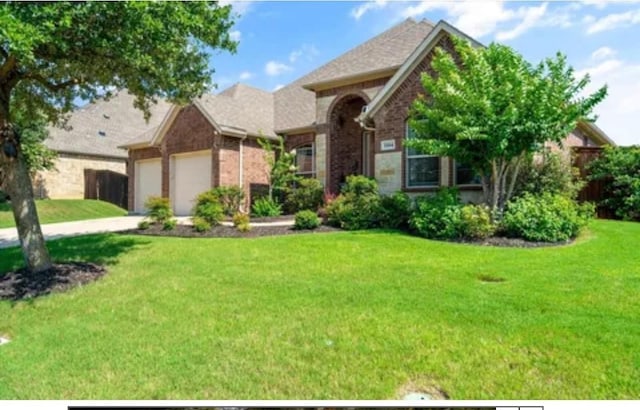 1104 Killian Dr, Mansfield, TX 76063 - view of front facade with a garage, a front lawn, brick siding, and driveway