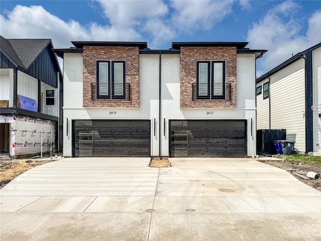 2417 Merlin St, Dallas, TX 75215 - contemporary home with an attached garage, concrete driveway, stucco siding, and brick siding