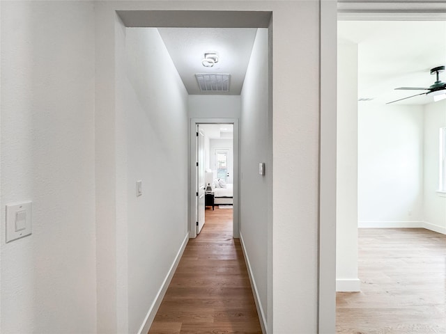 2417 Merlin St, Dallas, TX 75215 - corridor featuring wood finished floors and baseboards