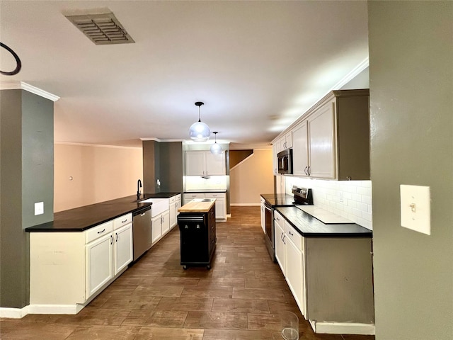 608 Marbury Way, Wylie, TX 75098 - kitchen with stainless steel appliances, dark wood-style floors, backsplash, dark countertops, and a sink