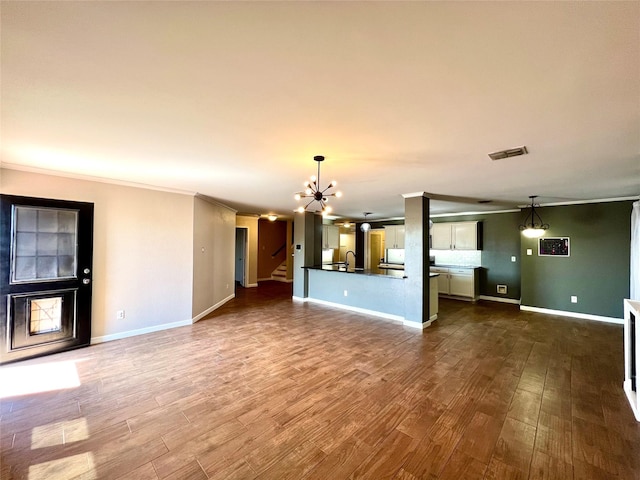 608 Marbury Way, Wylie, TX 75098 - unfurnished living room with a chandelier, dark wood-style flooring, a sink, baseboards, and ornamental molding