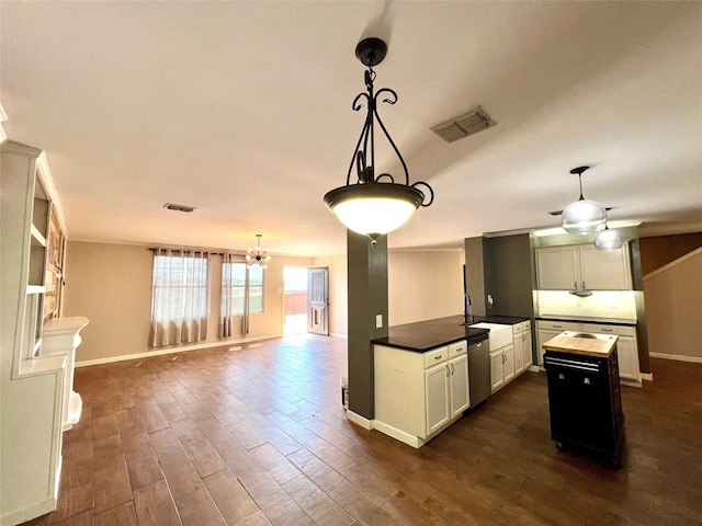 608 Marbury Way, Wylie, TX 75098 - kitchen featuring dark wood-style floors, stainless steel dishwasher, open floor plan, baseboards, and decorative light fixtures
