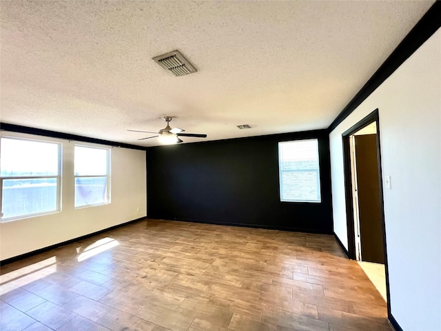 608 Marbury Way, Wylie, TX 75098 - empty room with healthy amount of natural light, a textured ceiling, a ceiling fan, light wood-type flooring, and baseboards