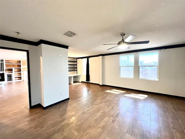 608 Marbury Way, Wylie, TX 75098 - spare room featuring ceiling fan, wood finished floors, baseboards, and a textured ceiling