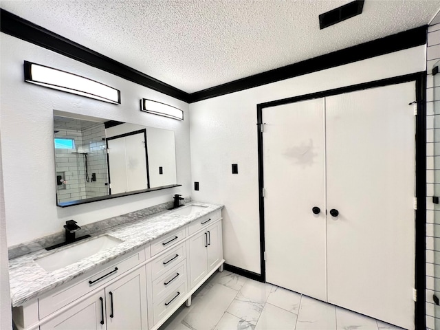608 Marbury Way, Wylie, TX 75098 - bathroom featuring a textured ceiling, marble finish flooring, double vanity, a stall shower, and crown molding
