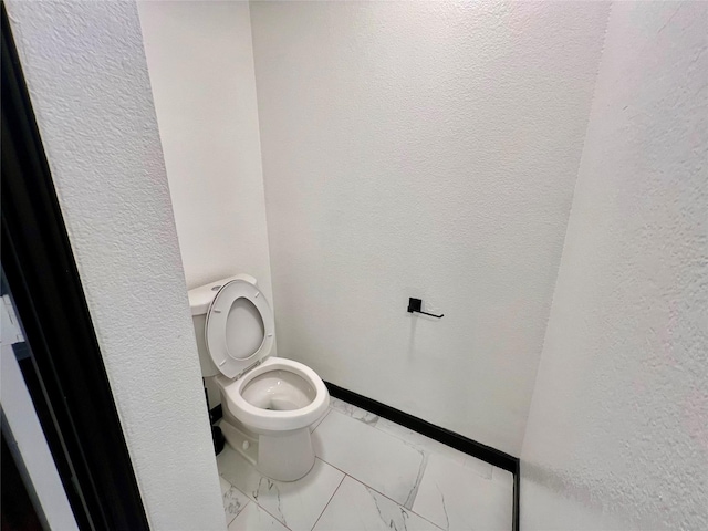 608 Marbury Way, Wylie, TX 75098 - bathroom with marble finish flooring, toilet, a textured wall, and baseboards