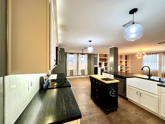 608 Marbury Way, Wylie, TX 75098 - kitchen featuring stainless steel appliances, dark countertops, a sink, and a chandelier