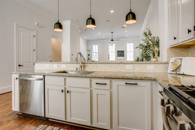2123 Diversey St, Dallas, TX 75201 - kitchen featuring stainless steel appliances, a sink, crown molding, white cabinets, and backsplash
