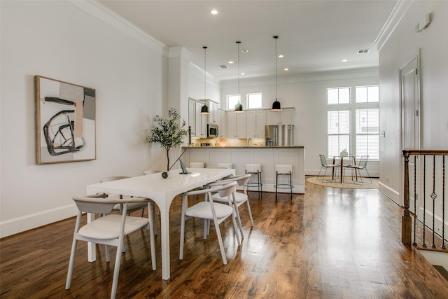 2123 Diversey St, Dallas, TX 75201 - dining room with crown molding, dark wood-type flooring, baseboards, and recessed lighting