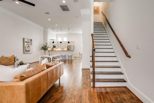 2123 Diversey St, Dallas, TX 75201 - living room featuring stairway, crown molding, wood finished floors, recessed lighting, and baseboards