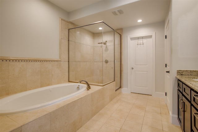 2123 Diversey St, Dallas, TX 75201 - full bath with a bath, vanity, a shower stall, tile patterned floors, and recessed lighting