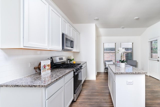 1215 Chapel Hill Dr, Anna, TX 75409 - kitchen featuring appliances with stainless steel finishes, a center island, dark wood-type flooring, and decorative backsplash