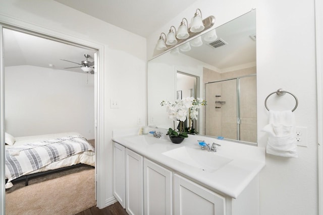 1215 Chapel Hill Dr, Anna, TX 75409 - full bathroom featuring double vanity, tiled shower, ensuite bath, ceiling fan, and wood finished floors