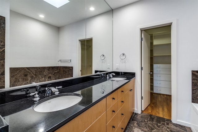 4100 Travis St Unit 19, Dallas, TX 75204 - full bathroom with double vanity, marble finish floors, a walk in closet, and recessed lighting
