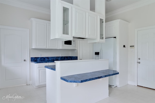 49 Turnbury Dr, Bossier City, LA 71111 - kitchen featuring white refrigerator with ice dispenser, light flooring, dark countertops, ornamental molding, and white cabinetry