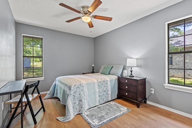 613 Locust St S, Sulphur Springs, TX 75482 - bedroom featuring multiple windows, wood finished floors, baseboards, and ceiling fan