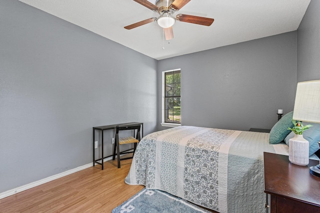 613 Locust St S, Sulphur Springs, TX 75482 - bedroom with wood finished floors, a ceiling fan, and baseboards