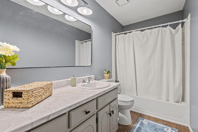 613 Locust St S, Sulphur Springs, TX 75482 - full bathroom featuring vanity, toilet, wood finished floors, and shower / tub combo