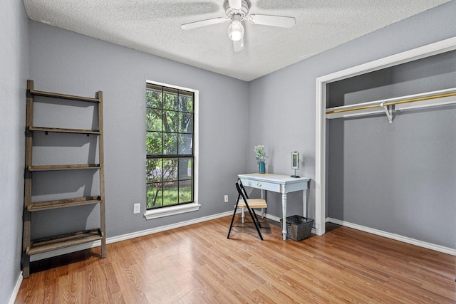 613 Locust St S, Sulphur Springs, TX 75482 - office featuring wood finished floors, a textured ceiling, ceiling fan, and baseboards