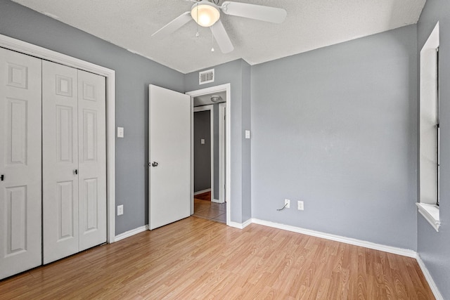 613 Locust St S, Sulphur Springs, TX 75482 - unfurnished bedroom with wood finished floors, a closet, baseboards, and ceiling fan