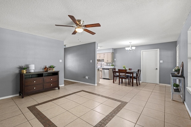 613 Locust St S, Sulphur Springs, TX 75482 - living room with ceiling fan, a chandelier, a textured ceiling, light tile patterned floors, and baseboards
