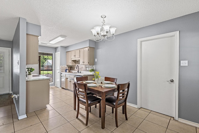613 Locust St S, Sulphur Springs, TX 75482 - dining area featuring a chandelier, light tile patterned floors, a textured ceiling, and baseboards