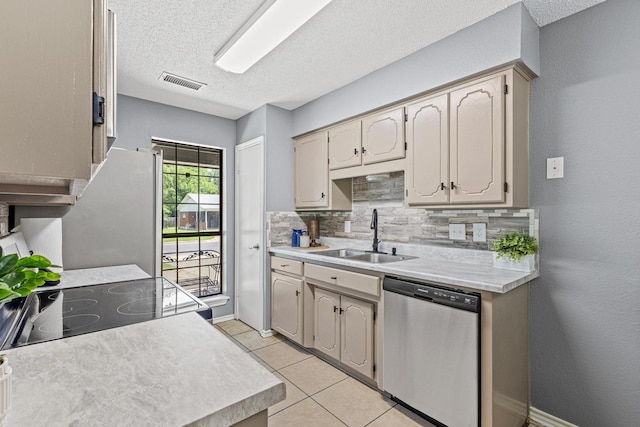 613 Locust St S, Sulphur Springs, TX 75482 - kitchen with stainless steel appliances, a sink, light countertops, backsplash, and a textured ceiling