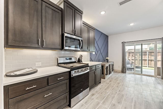 974 Mikaela Dr, Allen, TX 75013 - kitchen with appliances with stainless steel finishes, backsplash, light countertops, and recessed lighting
