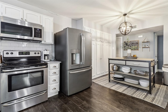 3713 Fairfield Dr, Carrollton, TX 75007 - kitchen with stainless steel appliances, white cabinetry, a chandelier, dark wood-style flooring, and tasteful backsplash