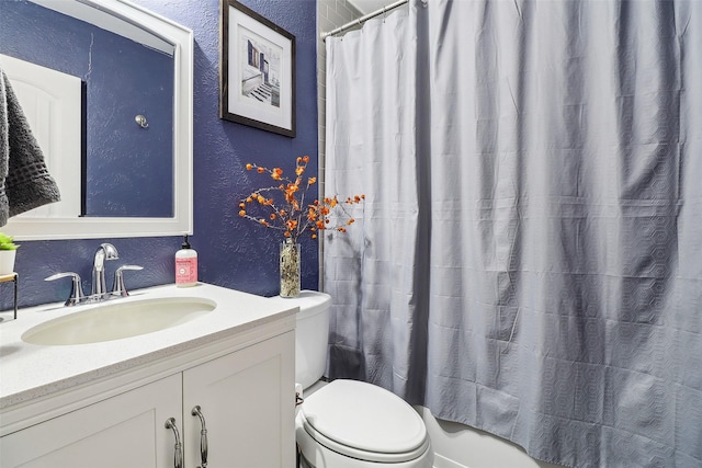 3713 Fairfield Dr, Carrollton, TX 75007 - full bathroom with a textured wall, toilet, vanity, and a shower with shower curtain