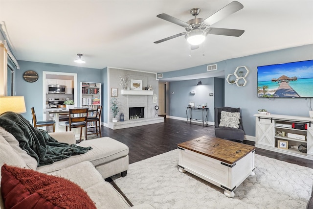 3713 Fairfield Dr, Carrollton, TX 75007 - living area with wood finished floors, a ceiling fan, a fireplace, and baseboards