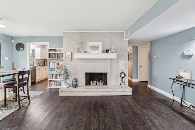 3713 Fairfield Dr, Carrollton, TX 75007 - living room with wood finished floors, baseboards, and a brick fireplace