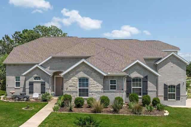 1124 Wishing Well Ct, Cedar Hill, TX 75104 - french country home with roof with shingles, a front yard, and brick siding