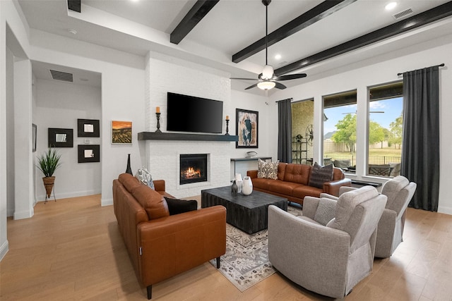 1804 Rockwood Ln, Mansfield, TX 76063 - living area with beamed ceiling, a brick fireplace, light wood-type flooring, baseboards, and recessed lighting