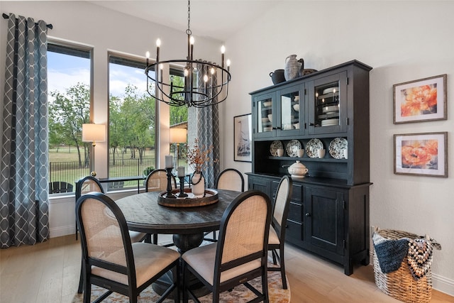 1804 Rockwood Ln, Mansfield, TX 76063 - dining room with a chandelier, healthy amount of natural light, light wood finished floors, and baseboards